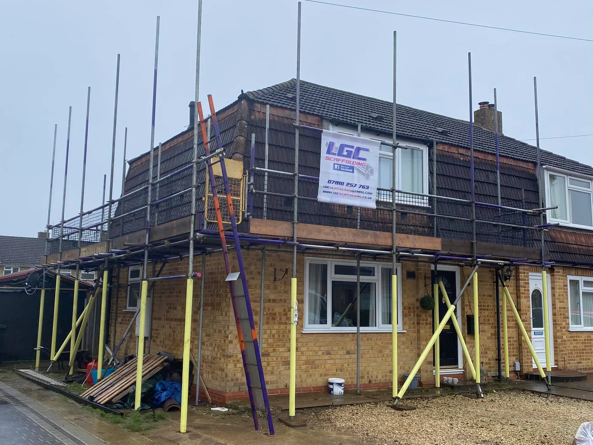 A house under construction with scaffolding around it.