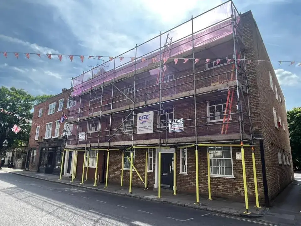 A large brick building with scaffolding around it.